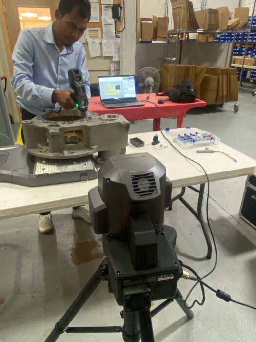 Technician 3D-scanning metal component in workshop