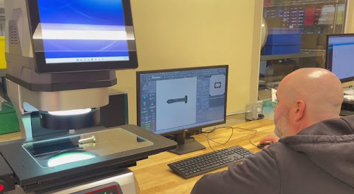 Technician scanning fastener on inspection workstation