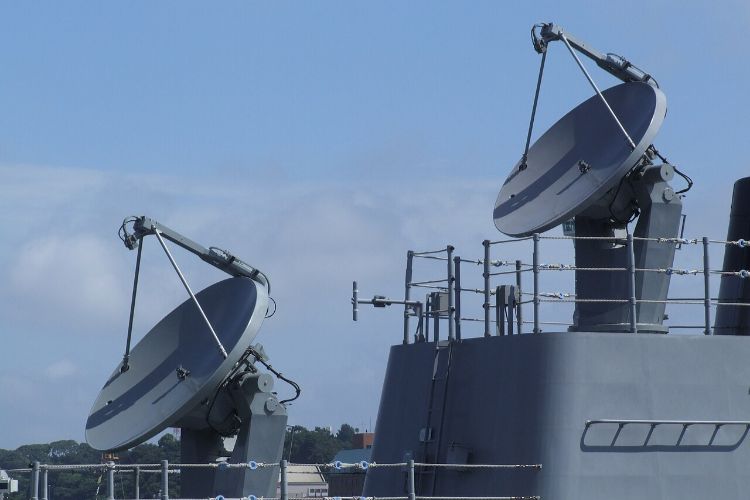 Ship-mounted satellite dishes against blue sky